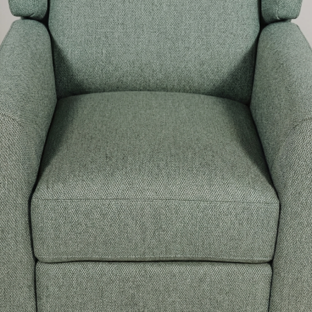 Sage upholstered armchair with textured fabric