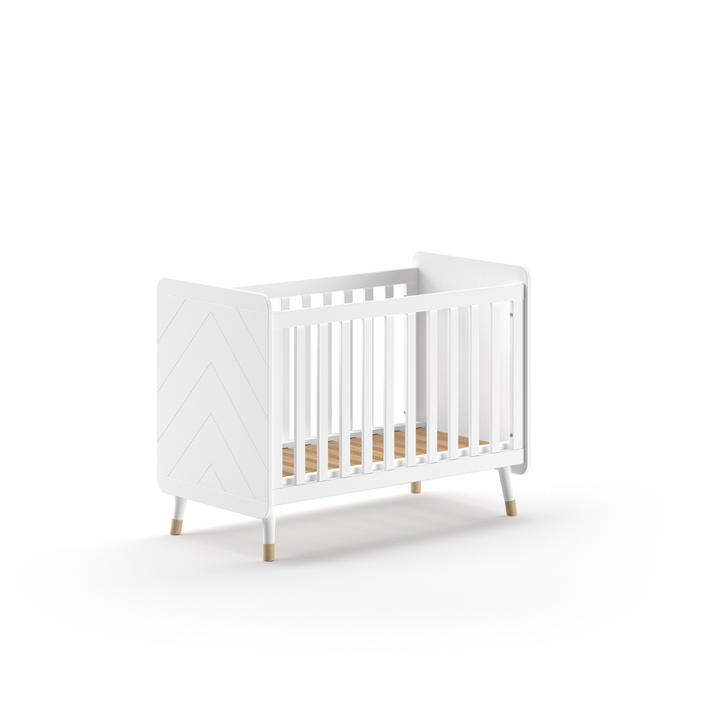 The Billy Baby Cot Bed in Satin White features a geometric graphic design, golden accents and an adjustable slatted base, perfect for a modern nursery setup