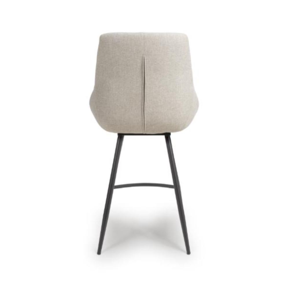 The Boden Counter Chair in Natural features soft upholstery, sophisticated pleats and strong black metal legs