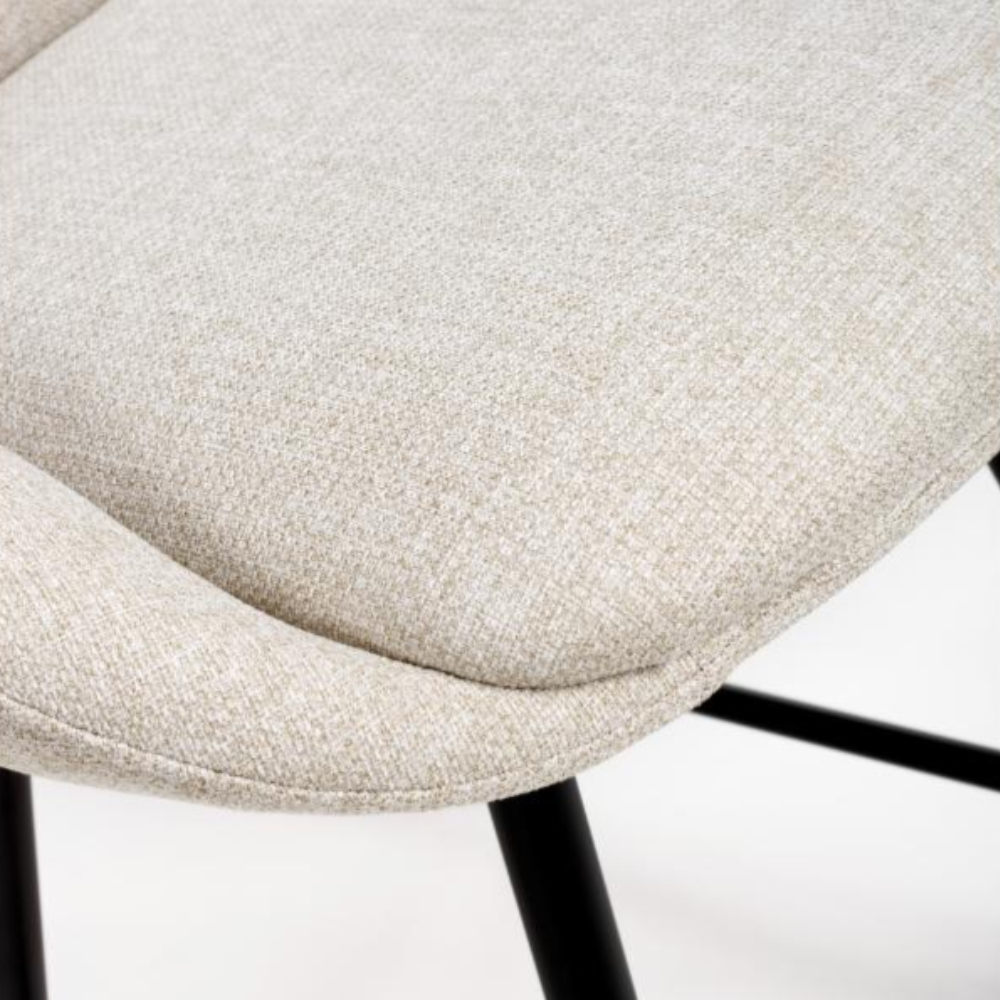The Boden Counter Chair in Natural features soft upholstery, sophisticated pleats and strong black metal legs