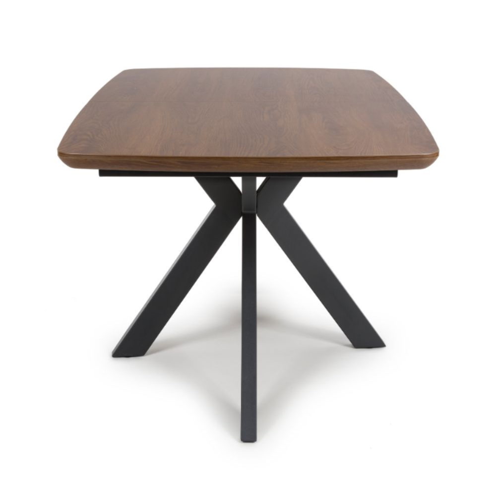 The Boston Extending Table, which ranges from 1400 to 1800mm, showcases an elegant smoked oak veneer, robust metal legs, and a seamless extension mechanism.