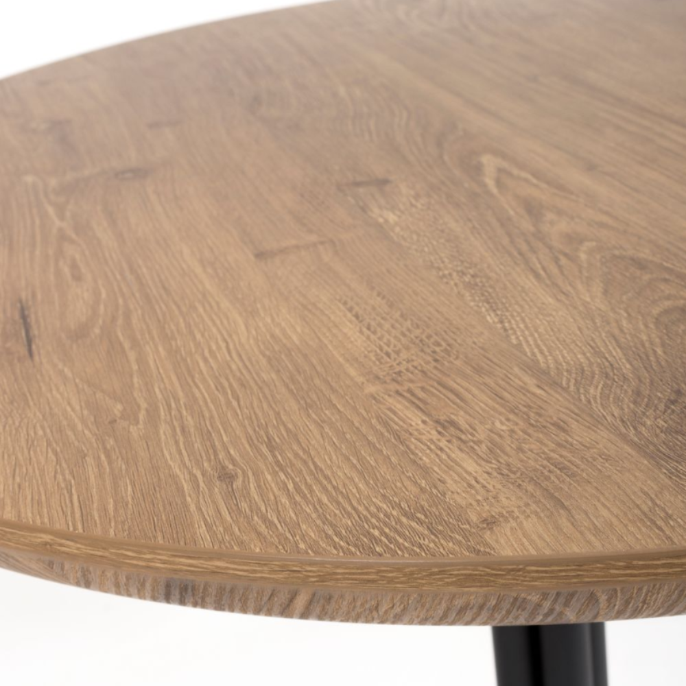 The Boston Round Table 800mm features a rustic oak veneer top, supported by a sleek black metal base making it ideal for compact dining areas.