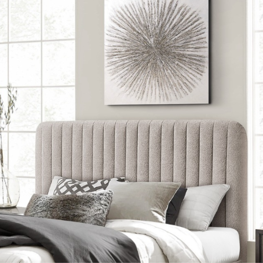 The Clarissa Bed in Grey or Beige features chic channelled upholstery, sturdy metal legs, and padded headboard.