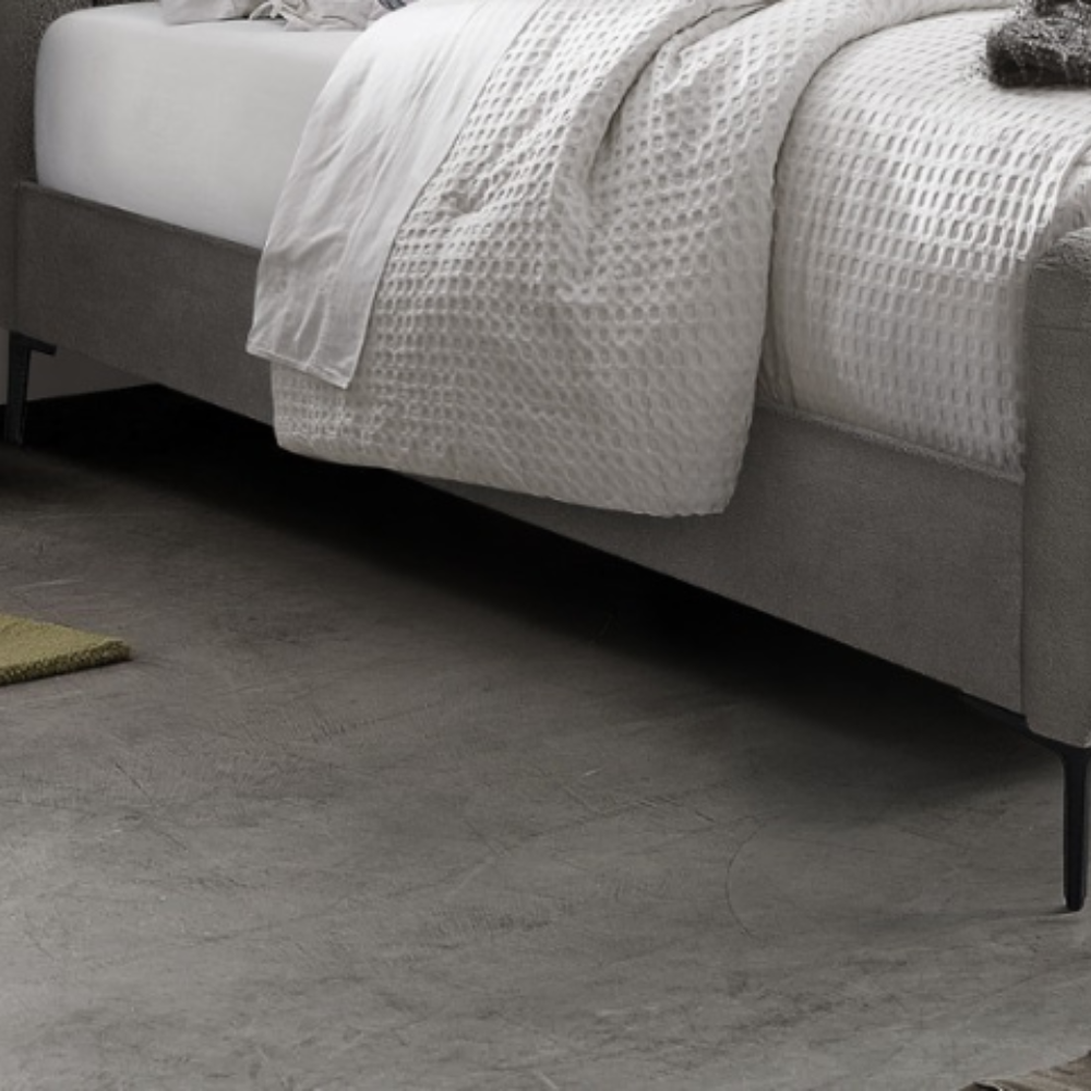 The Clarissa Bed in Grey or Beige features chic channelled upholstery, sturdy metal legs, and padded headboard.