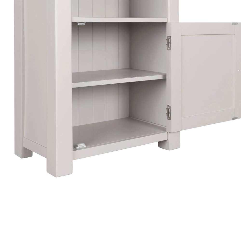 The Doune Tall Bookcase in Taupe features sleek design, oak veneer top and a hidden cabinet storage.