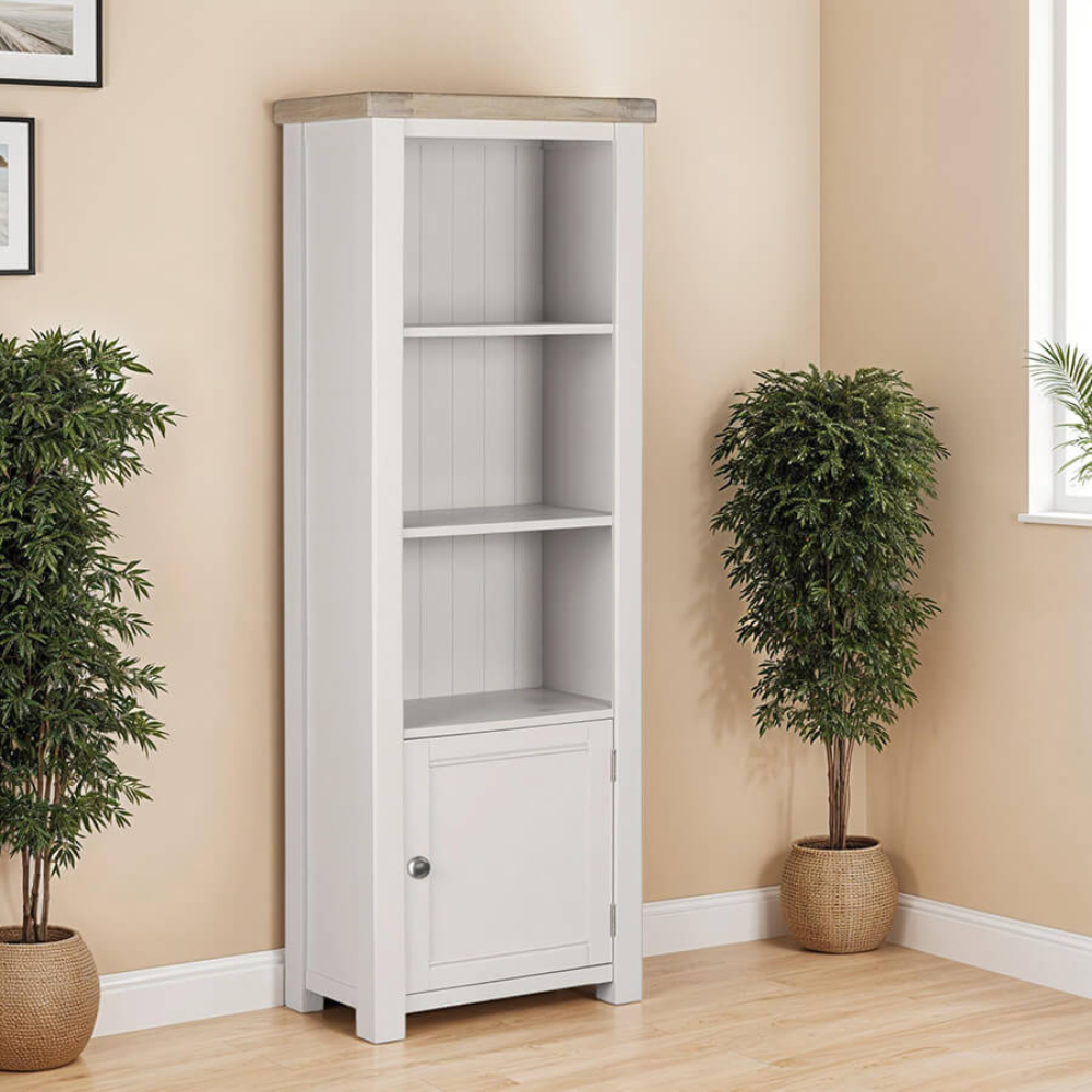 The Doune Tall Bookcase in Taupe features sleek design, oak veneer top and a hidden cabinet storage.