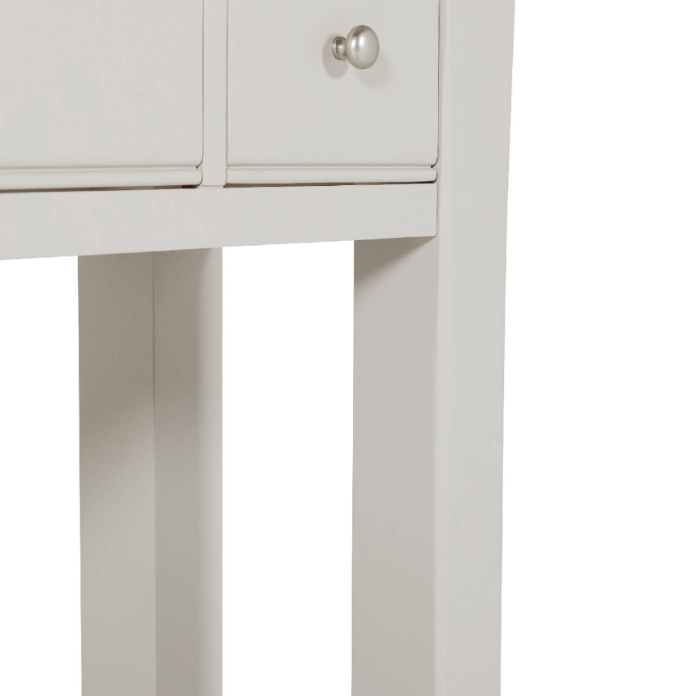 The Doune Console Table in Taupe features a sleek taupe finish, design with three drawers and a lower slatted shelf.
