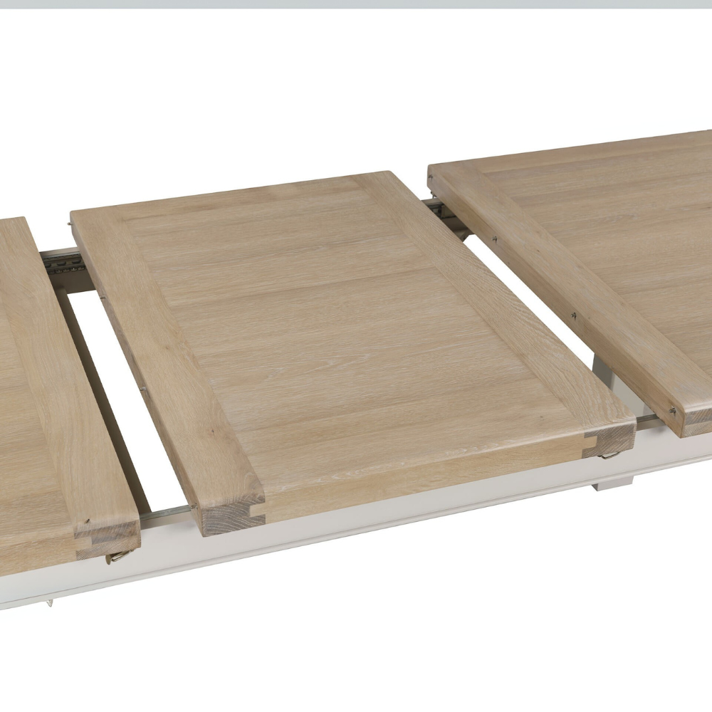The Doune 1200/1650 Extending Dining Table in Taupe features oak veneer top, taupe-painted legs and smooth extension