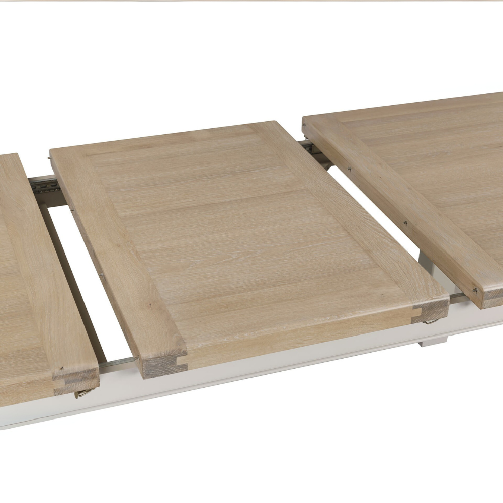 The Doune Extendable Dining Table in Taupe, 1800-2460mm features oak top, taupe-painted legs, and smooth extension mechanism.