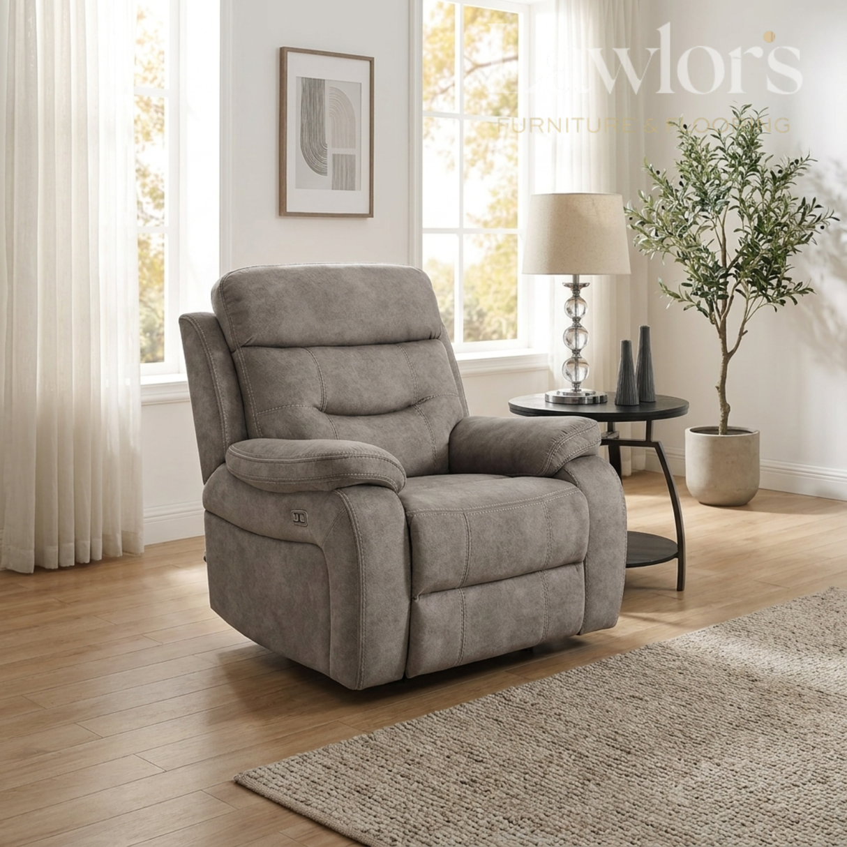 Cream recliner chair in a living room setting with a lamp and plant.