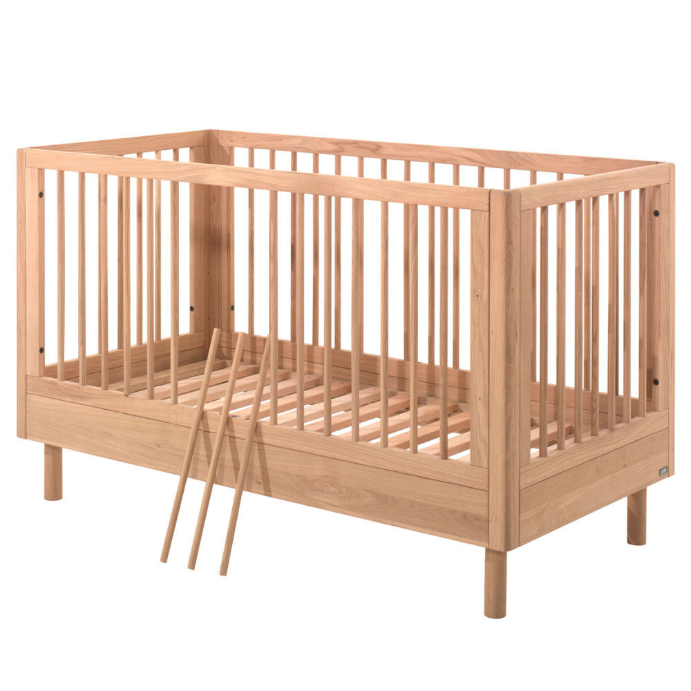 The Forrest Convertible Baby Bed 70 x 140cm in Oak transforms into a toddler bed for extended use & adjustable base with 3 heights, ideal for growing kids
