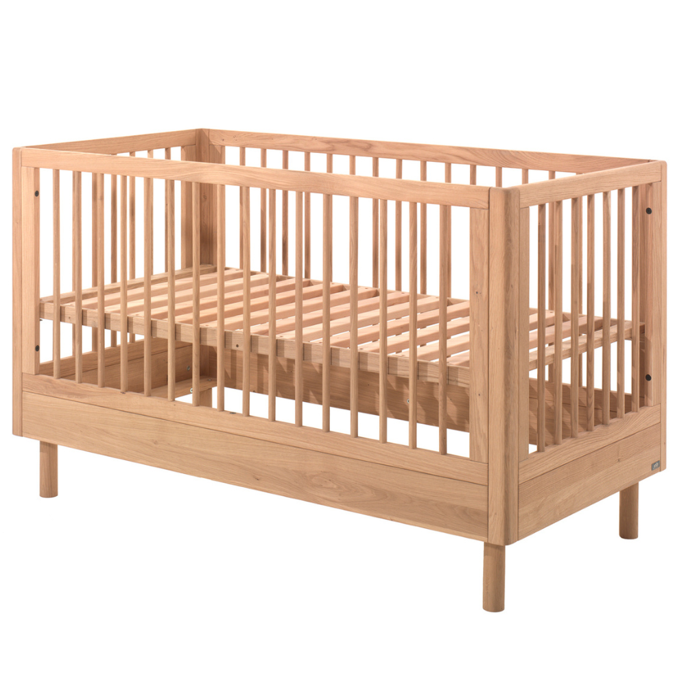 The Forrest Convertible Baby Bed 70 x 140cm in Oak transforms into a toddler bed for extended use & adjustable base with 3 heights, ideal for growing kids