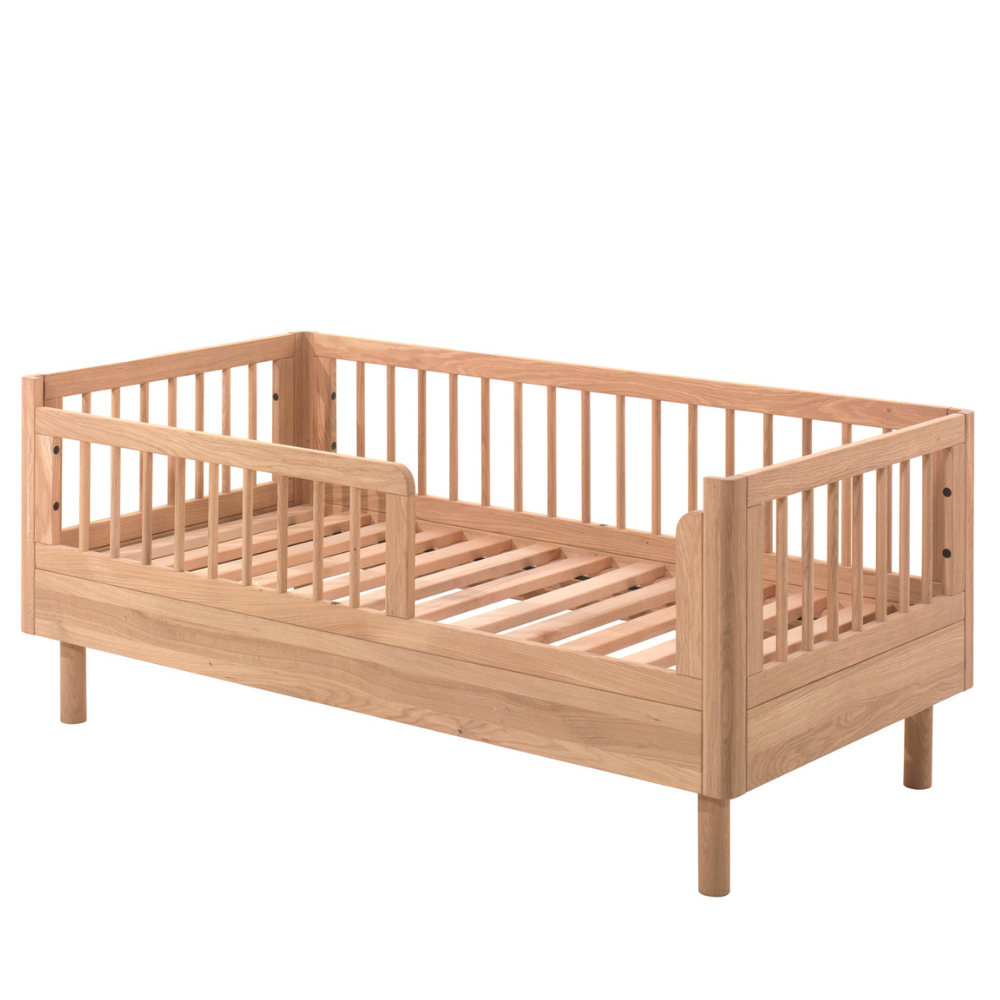 The Forrest Toddler Bed 70 x 140cm in Oak features raised sides for fall protection and solid European oak, ideal for transitioning from a crib