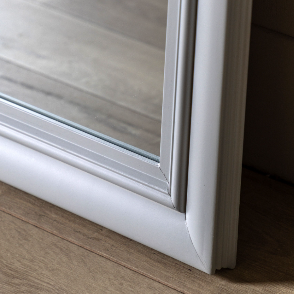 The Gallery Sherwood Window Mirror in Stone features a windowpane design, stone finish and durable build