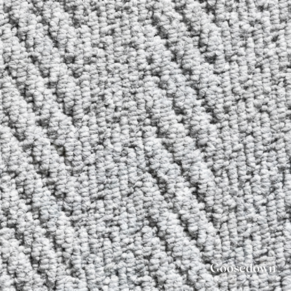 Close-up of textured gray carpet with 'Goosedown' branding.