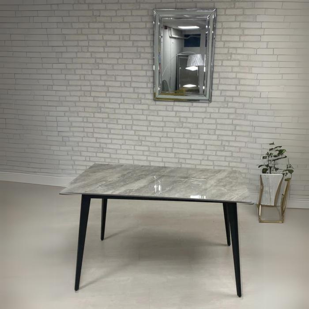 The Ivy 7pc Grey Dining Set features 1.6-meter stone table top, sleek black metal legs and dining chairs have matching legs.