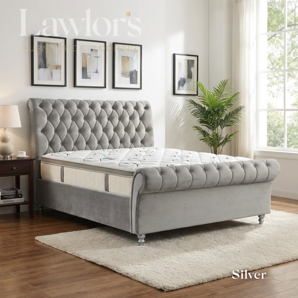 Silver upholstered bedframe and mattress in a well-lit bedroom bed pack