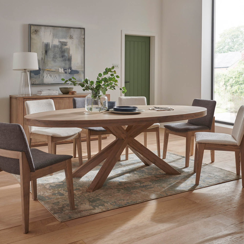 The Foxford Medium Oval Dining Table in Smoked Oak is crafted with stylish smoked oak veneer and supported by solid oak legs.