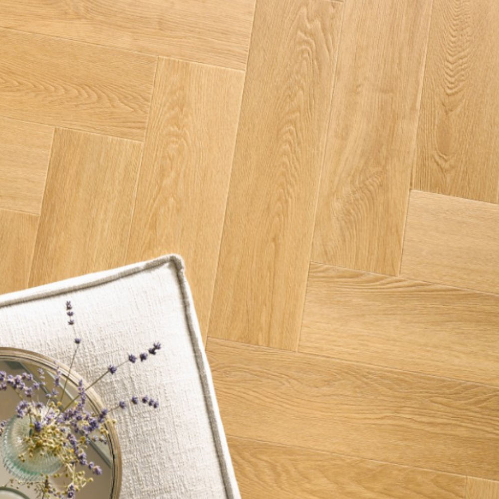 The Menor Oak Herringbone SPC Flooring features a timeless oak design, suitable for underfloor heating, Titanium Nano finish and a 25 year warranty