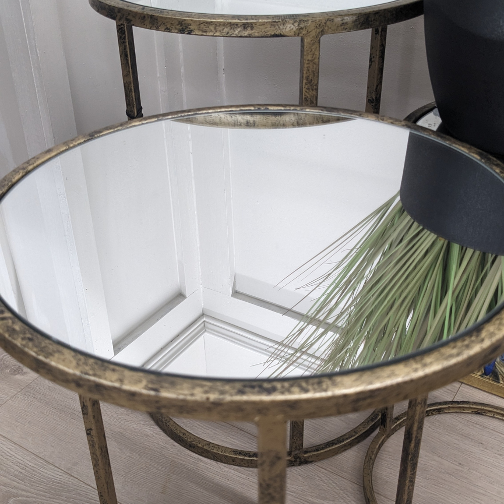 Add elegance with the Mirror Top Nest of Tables with an antique gold finish, mirrored tops and stackable design make this set of 3 stylish and practical
