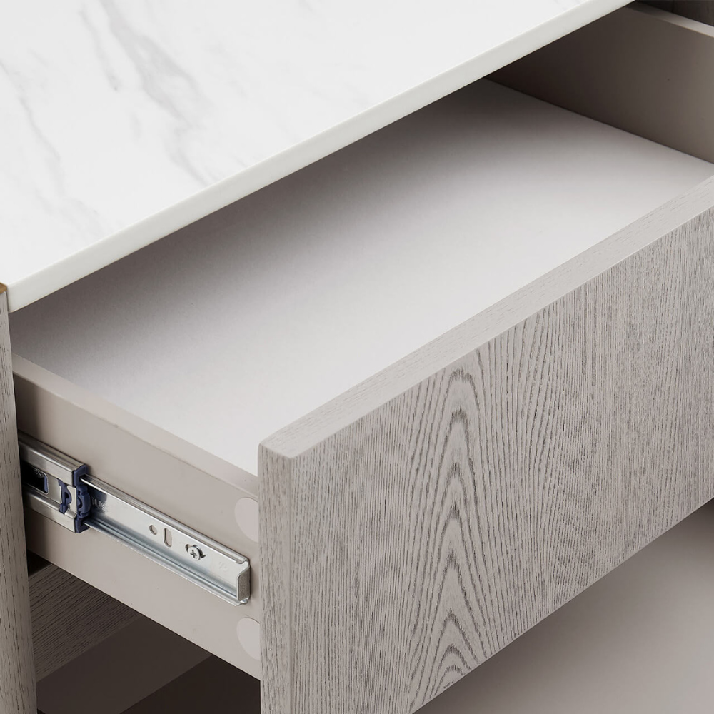 The Mondello 2 Drawer Bedside Table in Washed Oak features a luxurious sintered stone top, stainless steel accents and ample storage for a modern bedroom