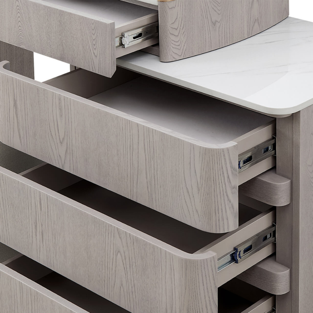 The Mondello 5 Drawer Dressing Table in Washed Oak features a sintered stone top, adjustable width and ample storage where luxury meets versatility