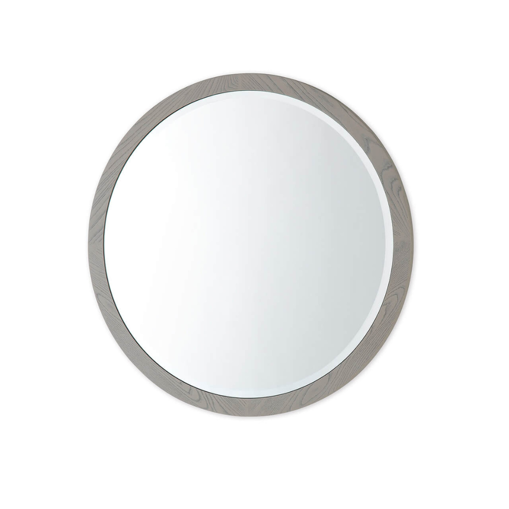 The Mondello Round Mirror in Washed Oak features a sleek frame and a tempered glass, perfect for pairing with furniture or as a standalone accent