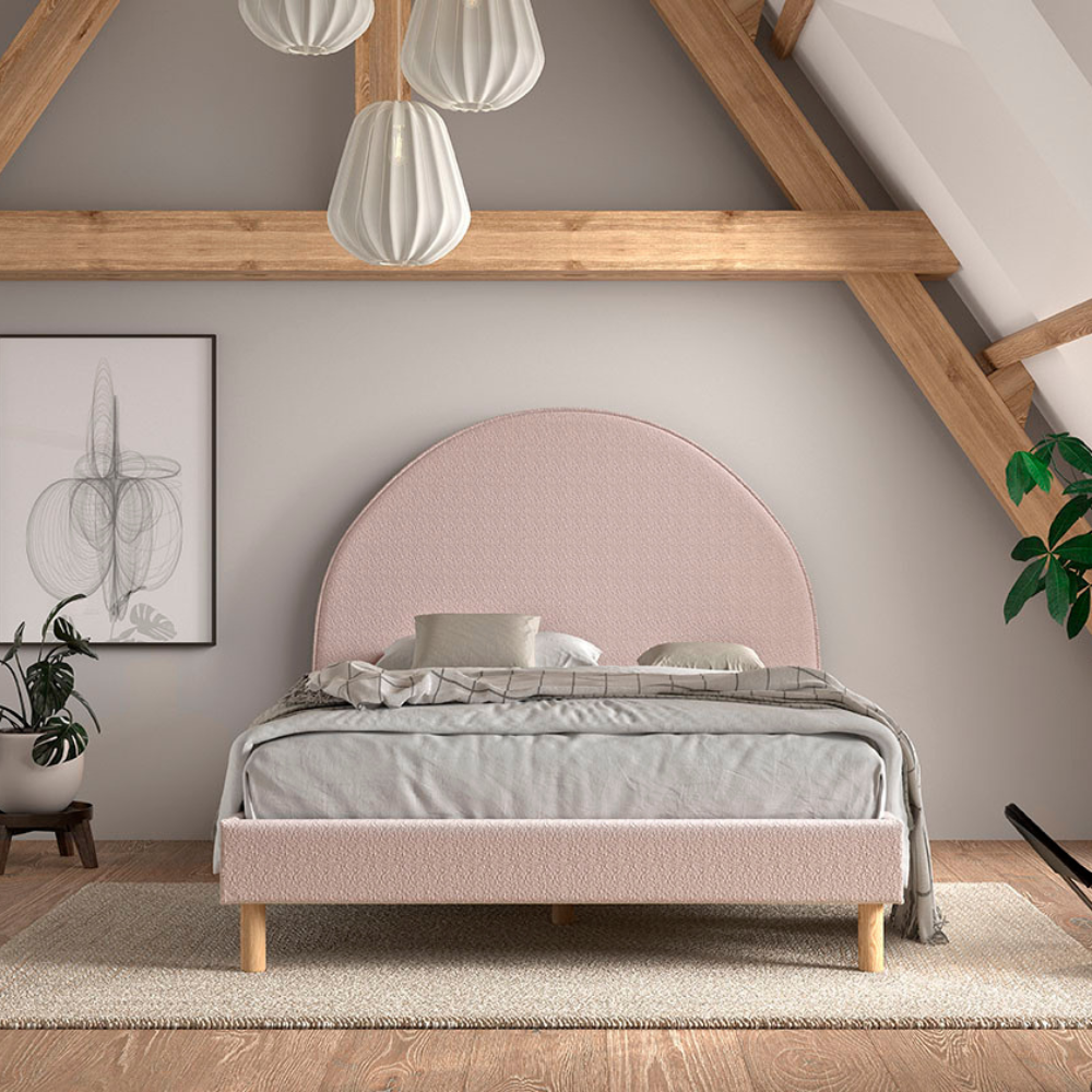 The Moon Kids Bed 140 x 200cm in Pink Boucle features a rounded headboard, soft upholstery and durable frame that is both cozy and stylish for any child
