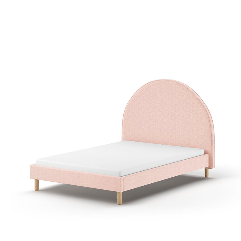 The Moon Kids Bed 140 x 200cm in Pink Boucle features a rounded headboard, soft upholstery and durable frame that is both cozy and stylish for any child