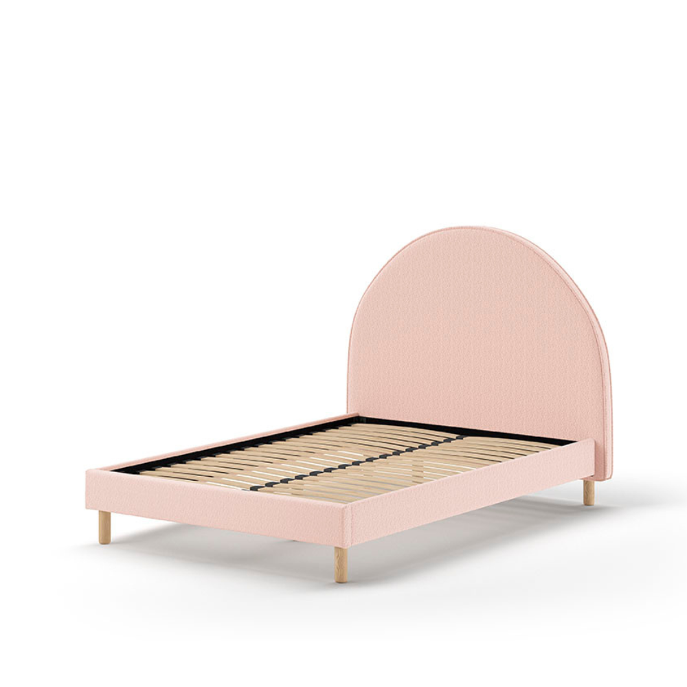 The Moon Kids Bed 140 x 200cm in Pink Boucle features a rounded headboard, soft upholstery and durable frame that is both cozy and stylish for any child