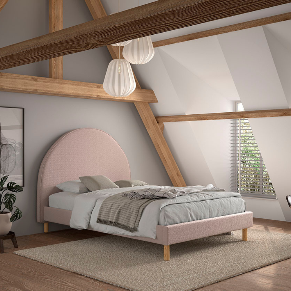 The Moon Kids Bed 140 x 200cm in Pink Boucle features a rounded headboard, soft upholstery and durable frame that is both cozy and stylish for any child