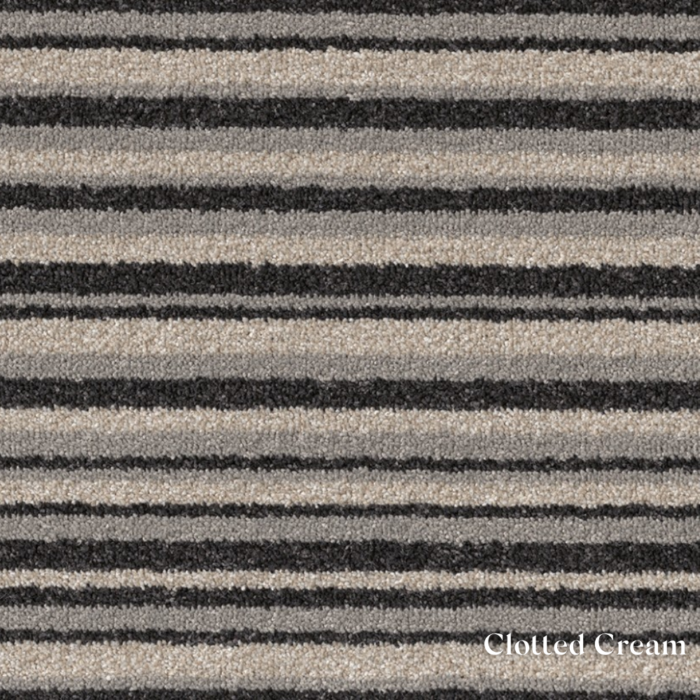 Patterned fabric with black and beige stripes labeled 'Clotted Cream'.