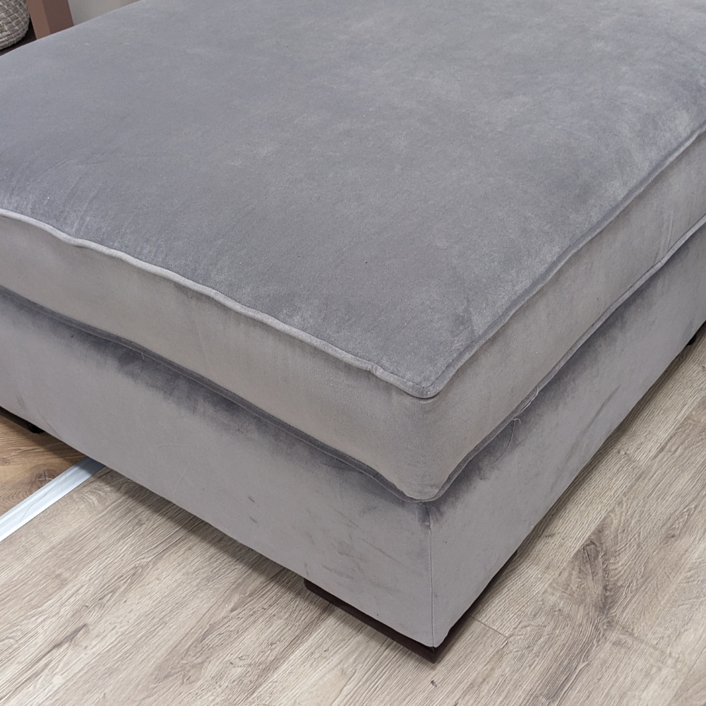 The Pillow Top Footstool in Grey with plush cushioned top, versatile design and durable fabric, perfect as a footrest, extra seat or casual coffee table