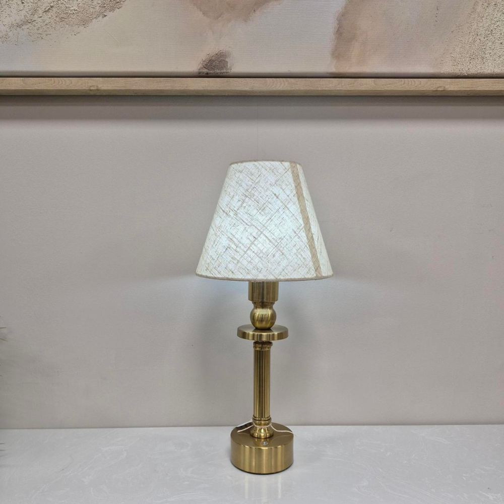 The Rechargeable LED Table Lamp 40cm offers RGBW colour, 3 light levels & tactile switch, an Antique Gold base & Linen Shade adding classic charm