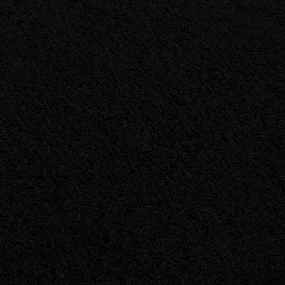Handmade in Ireland, the Scatter Box Cora Cushion 35x50cm in black features a recycled boucle fabric, feather fill and elegant self piped edging