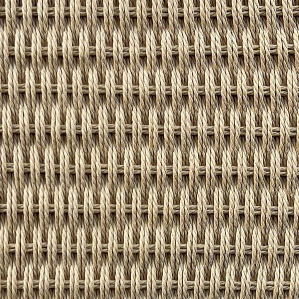 Close-up of a woven textile surface in warm beige and tan tones, showing a repeating basket-weave pattern.