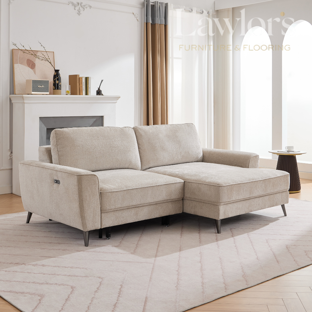 Beige LHF sectional sofa in a living room with a fireplace and large windows.