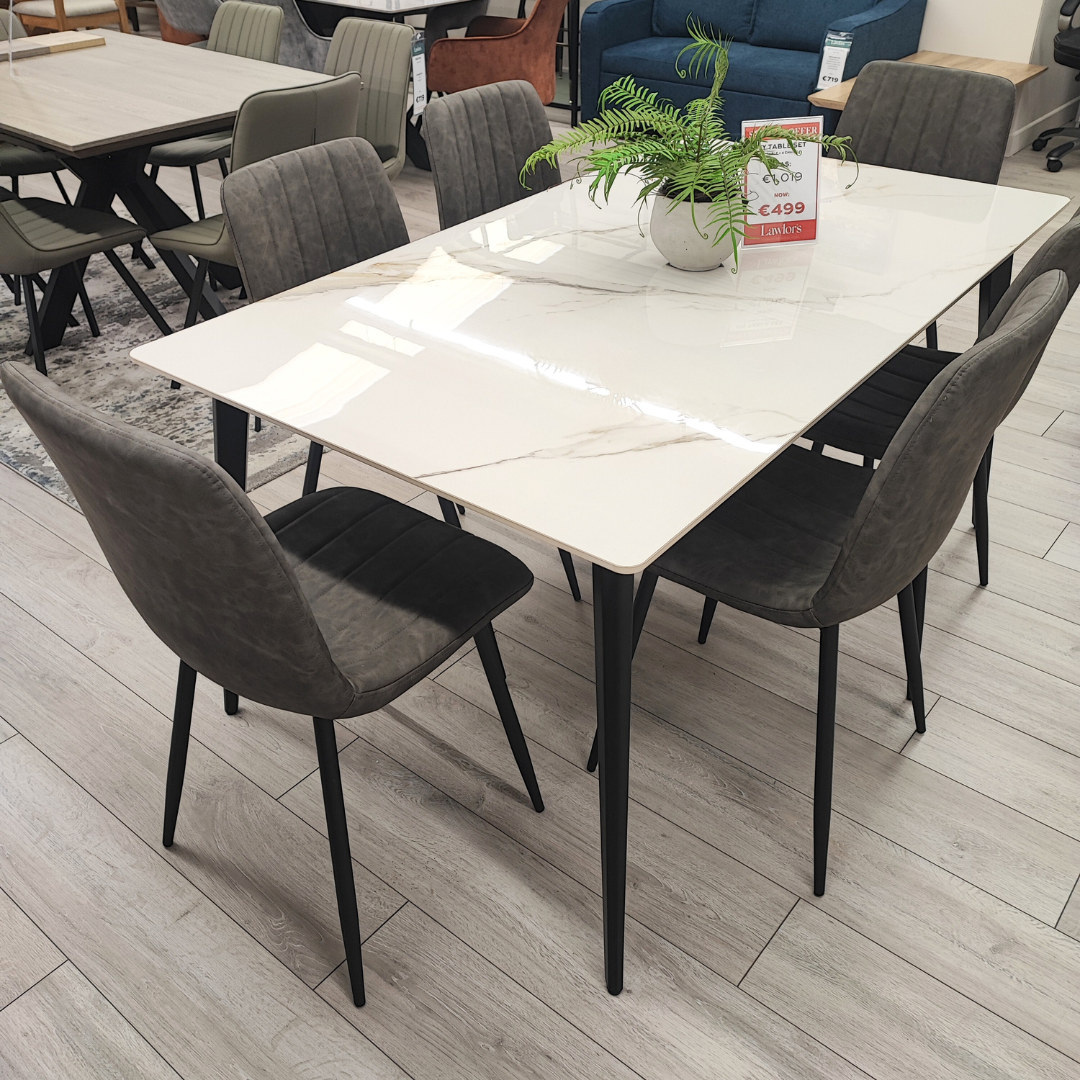 The Ivy 7pc Dining Set features 1.6-meter sintered stone table top in a off white hue, sleek black metal legs and dining chairs have matching legs and are finished vegan leather fabric