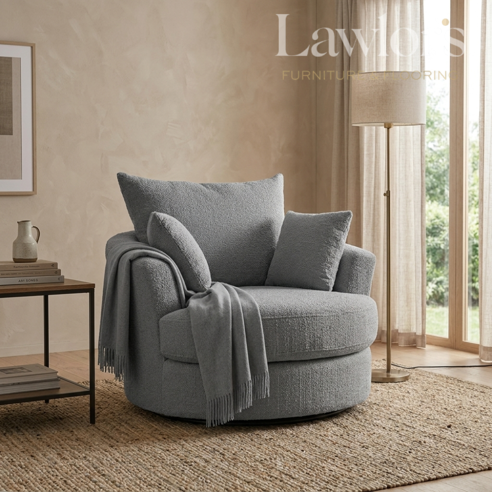 Grey swivel armchair with cushions and a blanket in a living room setting