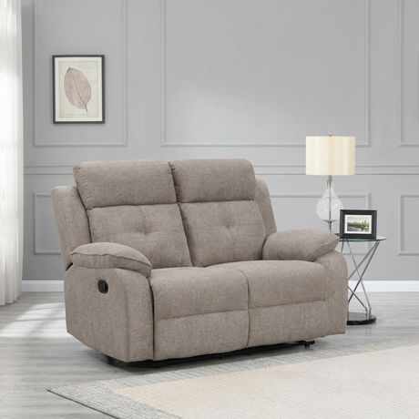 Light Brown recliner sofa in a living room setting with a lamp and framed picture on a gray wall.