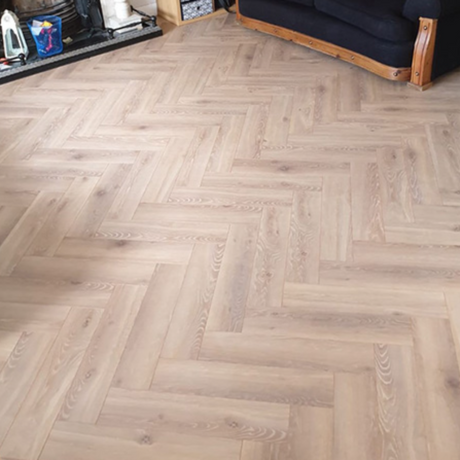 The Alicante Herringbone Laminate Flooring - 12mm features AC6-rated, underfloor heating compatible, classic herringbone design.