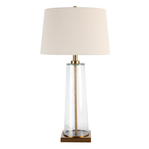 The elegant Amara Table Lamp Bubble Glass features a distinctive slanted base crafted from bubbled glass and brass fitting