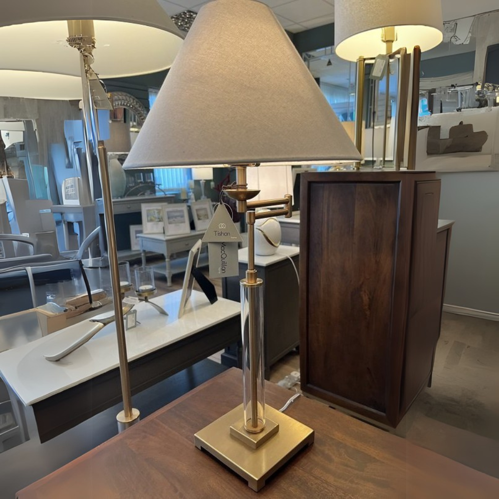 The tapered fabric shade of the 75cm antique brass Annery Table Lamp offers delicate lighting that is ideal for any desk, living area, or bedside.
