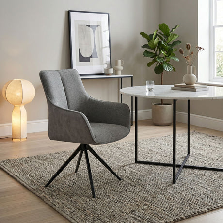 Grey fabric swivel chair in sitting room setting with dining table