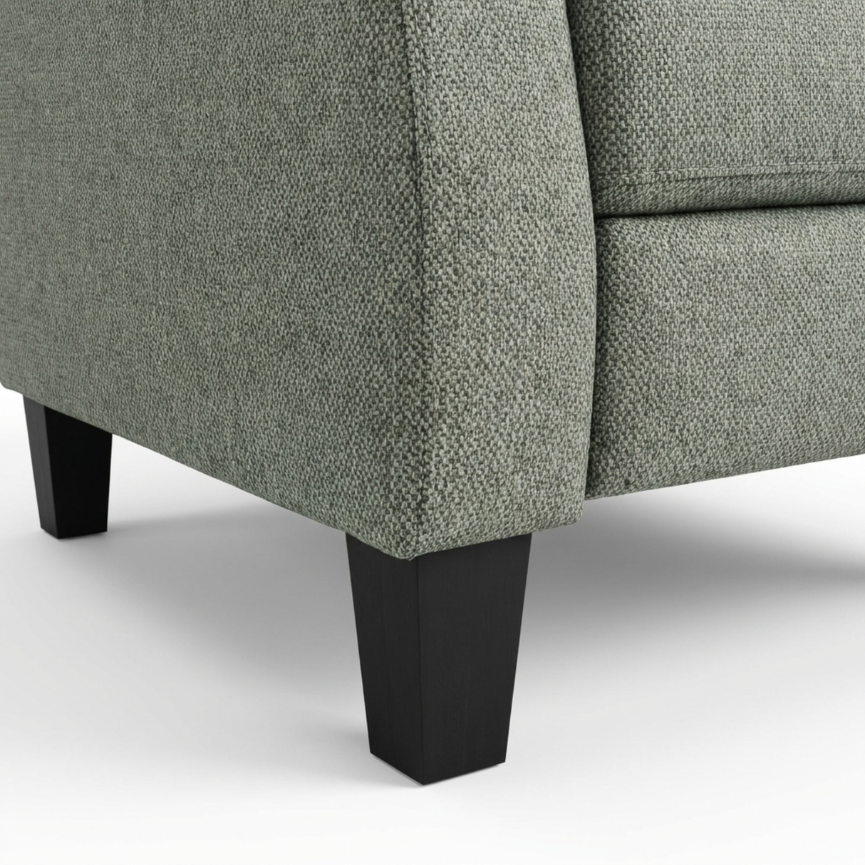 Close-up of a grey textured sofa with black legs on a white background