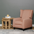 Brown armchair next to a wooden side table against a grey wall.