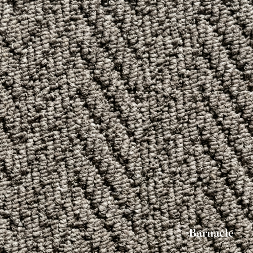 Close-up of textured gray carpet with 'Barnacle' branding.