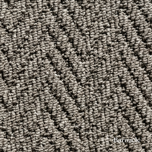 Close-up of textured gray carpet with 'Barnacle' branding.