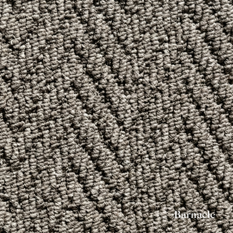 Close-up of textured gray carpet with 'Barnacle' branding.