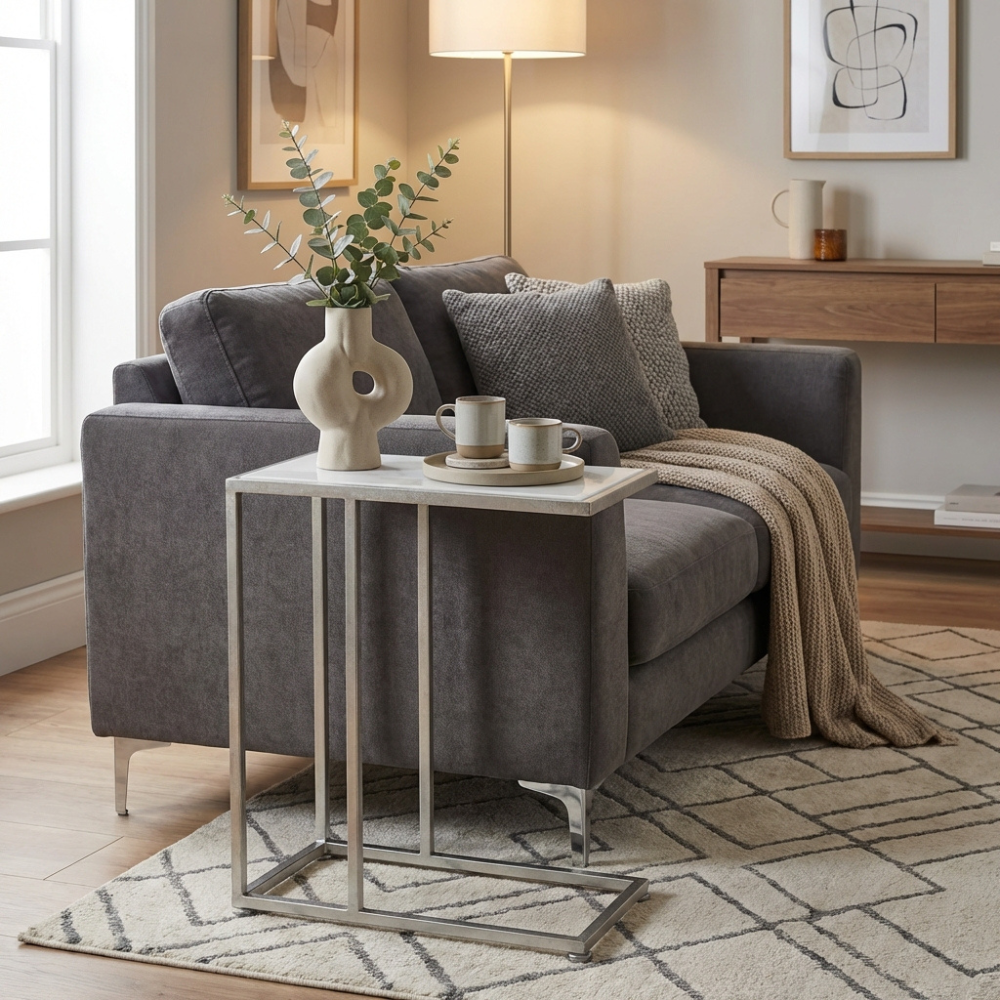 The Bella Sofa Table in Silver pairs a textured silver leaf finish with a white marble top, offering timeless elegance & functionality for your living space
